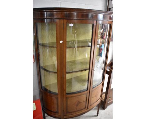 An Edwardian mahogany and inlaid bow fronted display cabinet on square tapered legs , width approx. w 114cm x h 170cm
Conditi