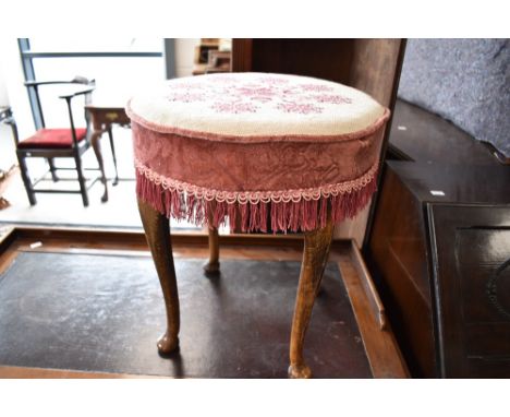 An early to mid 20th Century dressing table stool having circular woolwork top