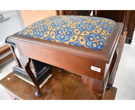 A traditional mahogany piano stool, having woolwork seat , and some sheet music books