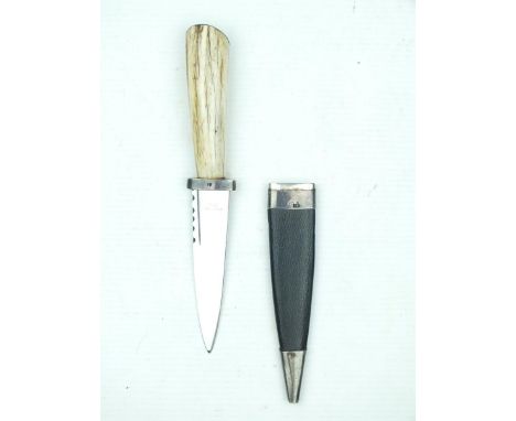 A silver mounted Skean Dhub, 8.5cm fullered clean blade with faceted back edge and marked STAINLESS STEEL, polished horn grip