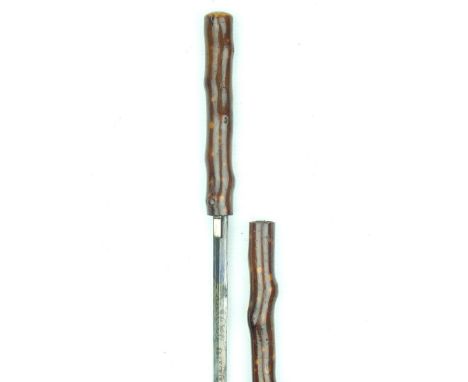 A late 19th Century briar effect sword stick, 67.5cm flattened diamond section blade with blued and gilt decoration, faded, a