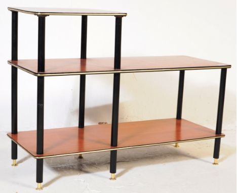 A vintage mid 20th century three stepped tier display stand.&nbsp; The stand with teak shelves having banded edges. The shelv