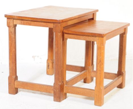 A vintage Robert 'Mouseman' Thompson oak nest of two tables. Having rectangular tops over four octagonal leg joined by stretc