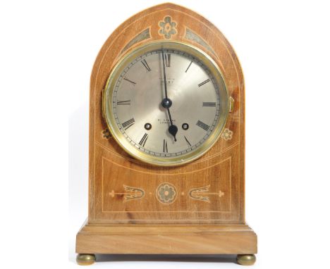 An early 20th century Arts &amp; Crafts mahogany 8-day dome-top mantel clock, examined by Dent of London, white enamel dial w