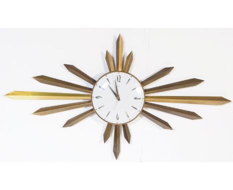 An early vintage mid 20th century 1960's Metamec sunburst / star burst wall clock. The brass clock having&nbsp;signed white '