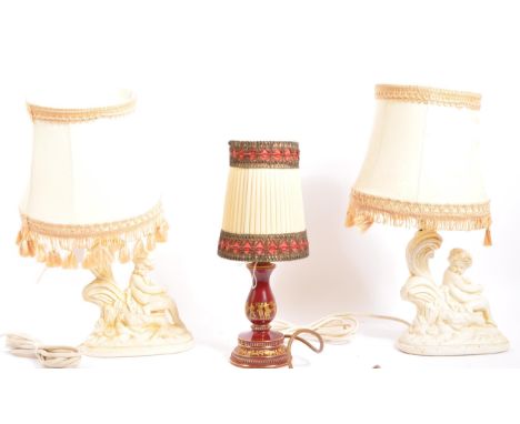 A collection of three 20th century vintage table lamps to include a pair of plaster lamps modelled in the form of putti seate