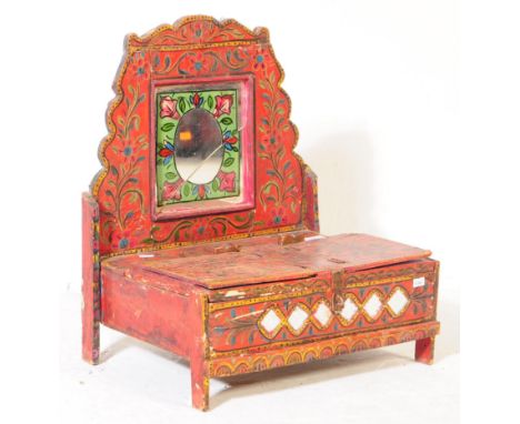 A vintage 20th century Indian Singhasan with hand painted floral leaves in a red ground and cracked central oval mirror. With