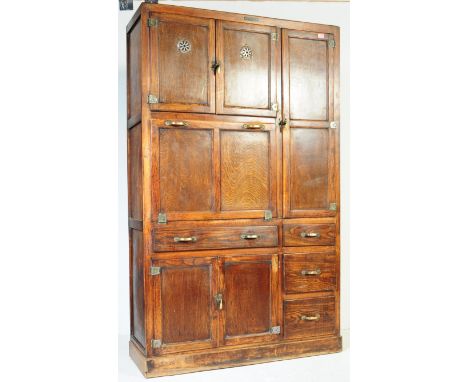 A vintage 20th century oak kitchen larder pantry cabinet. Of rectangular form with a configuration of doors, cabinets and dra