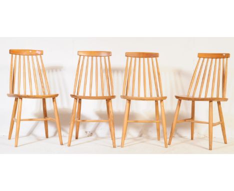 A set of four vintage 20th century beech spindle back dining chairs. Having a single support horizontal slat into stick spind