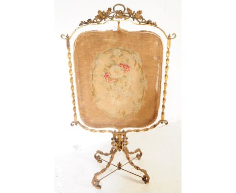 A 19th Century Victorian gilt metal fire screen / discretion screen with revolving central needlepoint tapestry. The gilt met