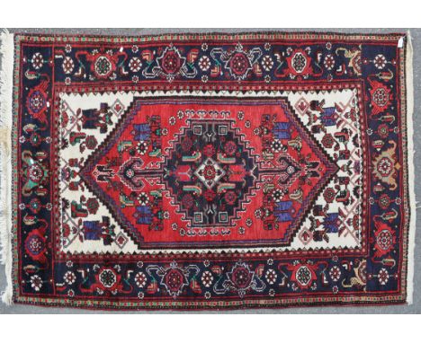A vintage 20th century circa 1970s Persian Islamic Hamedan carpet floor rug. Having a central medallion in a shaped panel enc