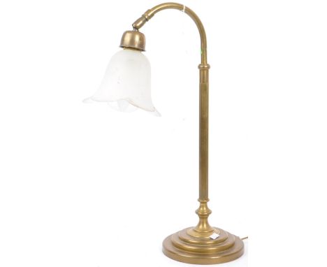 A 20th century brass and glass table lamp. The lamp having frosted clear tulip shade over a reeded columnar shaft upon a circ