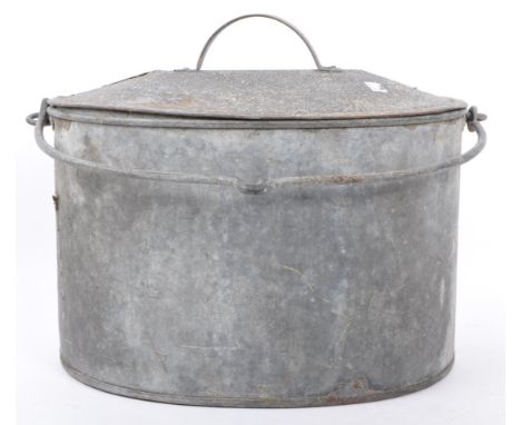 A vintage 20th century galvanized zinc cooking pot / laundry bucket. Having an oval lid with carry handle to top. Sits in a d