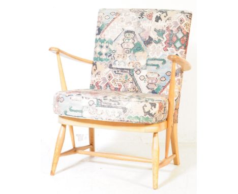 Ercol Furniture - A mid 20th century beech and elm easy armchair. With drop in upholstered floral cushioned seat and back res