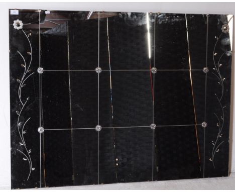 A mid century Venetian style rectangular wall mirror. The mirror with frameless sides, acid etched decoration of leaf work to
