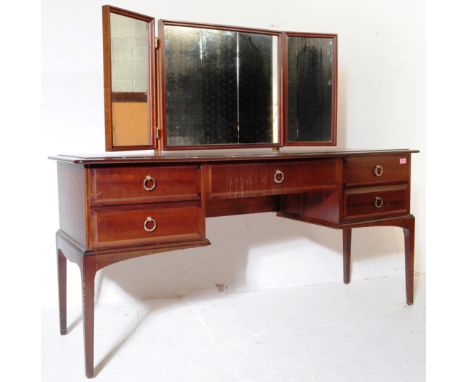 A vintage 1980&rsquo;s Stag Minstrel African cherry wood dressing table having a single long drawer to the centre over the kn