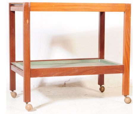 A vintage mid 20th century teak two tier serving / butlers trolley. Of rectangular form with drop in green trays on a teak fr