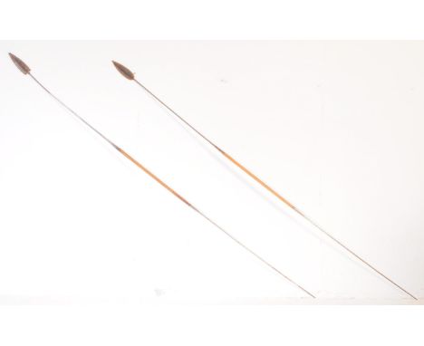 A pair of vintage 20th century wood and stainless steel tribal throwing spears. Having carved turned wooden handles and leath