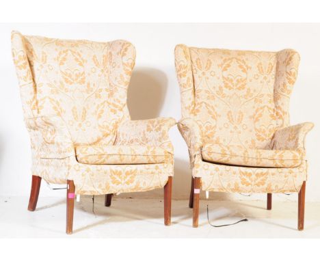 Parker Knoll - A pair of vintage mid 20th century lounge armchairs. Having wing back padded back rests, with a drop in cushio