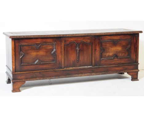 A vintage mid 20th century oak coffer / ottoman / blanket box. Of rectangular form with hinged lid opening to reveal a spacio