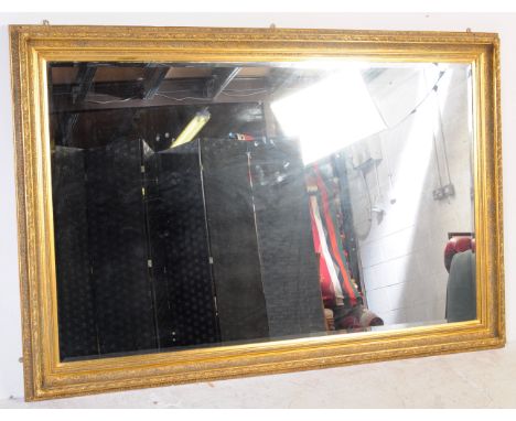 A vintage 20th century reproduction wall mirror having&nbsp;gilt resin&nbsp;frame with scrollwork decoration to frame of rect