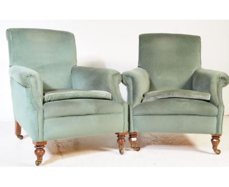 A pair of vintage 20th century lounge easy armchairs. In the manner of Howard. Having a rectangular cushioned padded back res