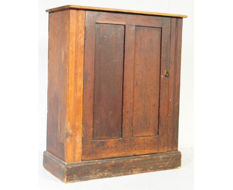 Late 19th century pine and pitch pine wood estate cupboard bookcase. Raised on a plinth base with single door flanked by reed