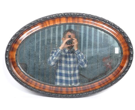A 19th century Victorian oval wall hanging mirror. The mirror having frame with beaded and braided type decoration with hangi