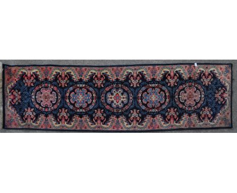 A vintage 20th century Persian Islamic Lillihan carpet floor rug. Having repeating floral medallions, encapsulated in a blue 