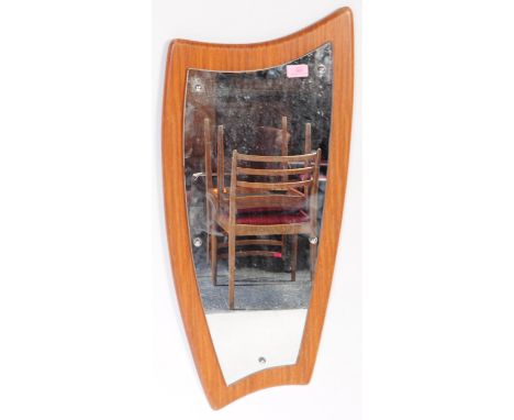 A vintage 20th century Danish inspired teak atomic style wall mirror having mirror glass on teak board of irregular form. Mea