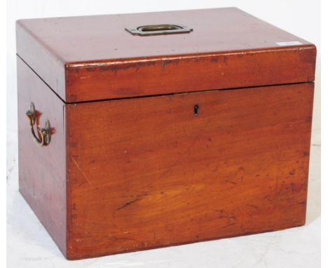 An early 20th century large mahogany cutlery canteen having inset brass campaign style handle atop, opening to reveal an appo