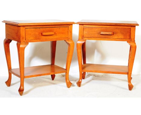 A pair of vintage 20th century oak two tier bedside tables. Of rectangular form with a single drawer, on cabriole legs with u