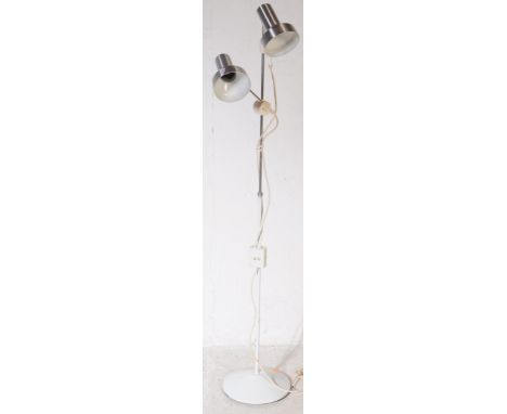 A retro 20th Century rise and fall adjustable standard lamp light having twin metal spot lights supported by a single stem. A