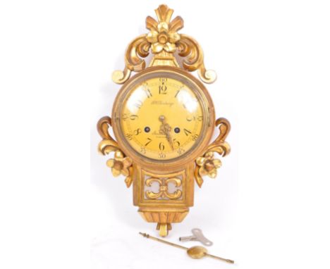 F. W. Tornberg - A 20th century Swedish F. W. Tornberg of Stockholm gilt wood wall clock. The clock face having Arabic numera