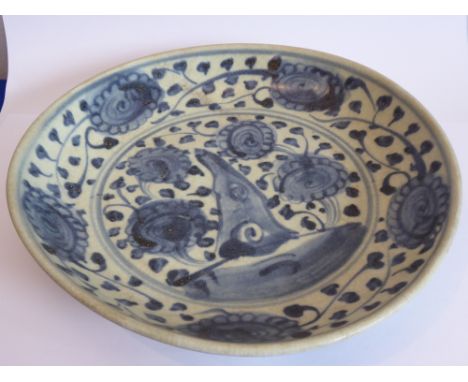 An 18th/19th century Chinese porcelain plate; hand-decorated in underglaze blue with stylised scrolling lotus etc. (probably 