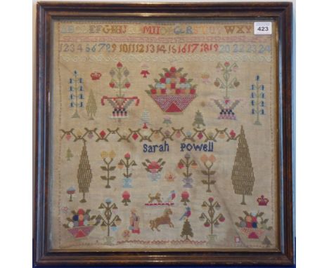 A walnut-framed and glazed needlework sampler with alphabet, numerals, various decorative symbols, animals, figures etc. by S