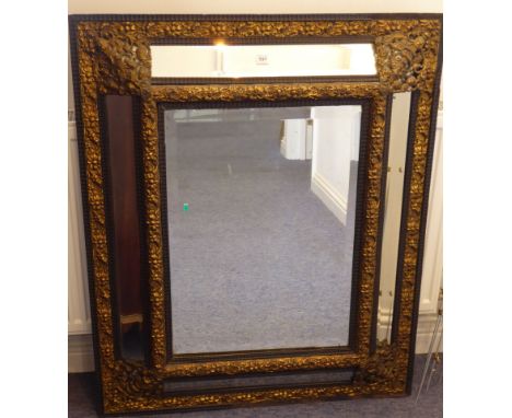 A good Venetian-style and gilt-metal mounted wallhanging looking glass; the single hand-bevelled rectangular plate flanked by