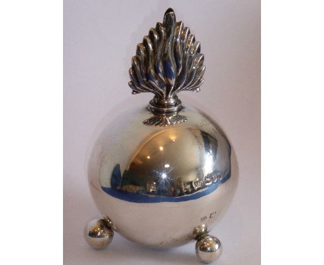 A regimental hallmarked silver table lighter; modelled as an early grenade,  screw stopper as flames above three ball feet; m