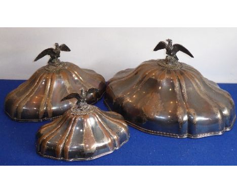 A set of three graduated late-18th / early-19th century Sheffield plated meat covers; each surmounted with an open-winged eag