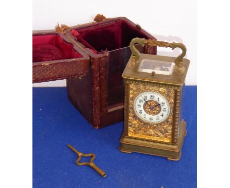 A 19th century eight-day gilt-metal and glass sided repeater carriage clock with leather case; cream enamel chapter ring with