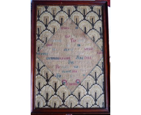 A rare framed and glazed early 18th century needlework sampler; central lozenge detailing The Lord's Prayer, dated 1731, old 