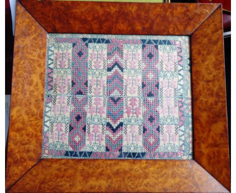 A very intricately sewn mid-19th century sampler depicting three vertical bands with various chevrons and patterns flanked by