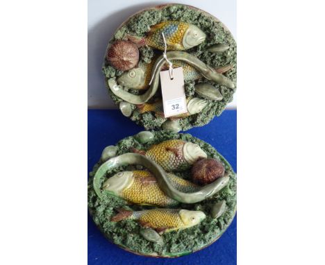 A pair of late 19th century Portuguese ceramic wall hanging reliefs in the style of Bernard Palissy; each encrusted with frui