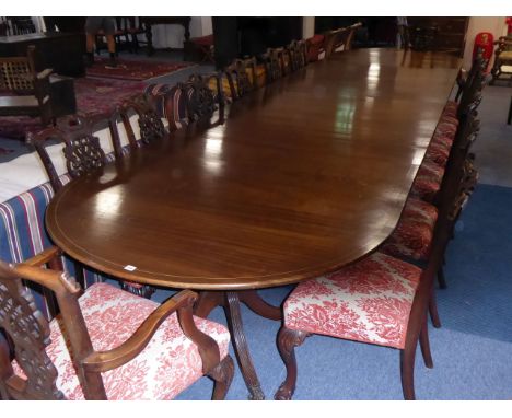 A fine quality Regency-style oval mahogany dining table having extra leaves; the boxwood-strung top above Regency-style four-