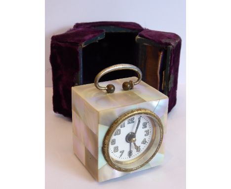 An early 20th century miniature mother of pearl cased travelling alarm clock; original mauve velvet box (distressed); white e