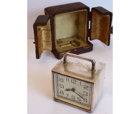 A good early 20th century silver-plate cased miniature travelling clock; the rectangular Art Deco style dial with Arabic nume