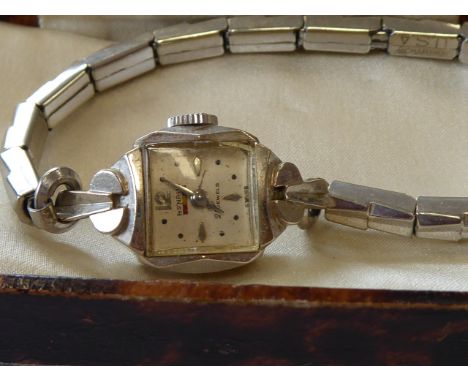 A lady's 14-carat white gold cased dress wristwatch; the square dial with Arabic numerals, baton markers and signed Benrus (b