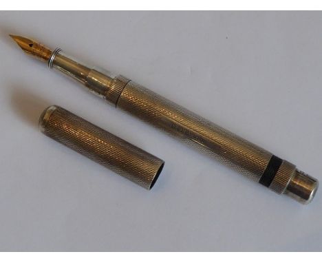 An early 20th century silver cased fountain pen, The De La Rue (London) Onoto fountain pen; engine-turned outer case, vacant 