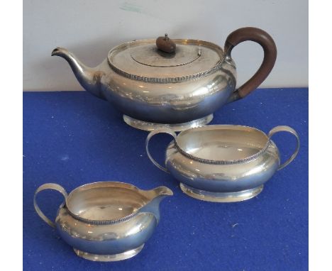 A heavy hallmarked silver early 20th century three-piece tea service comprising teapot, two-handled sugar and cream jug; each