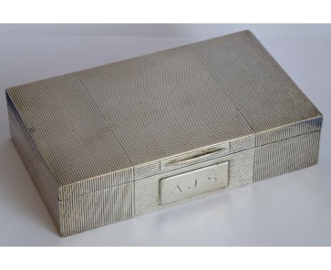 A rectangular hallmarked silver cigarette case; engine-turned decoration and the hinged lid with thumbpiece above rectangular